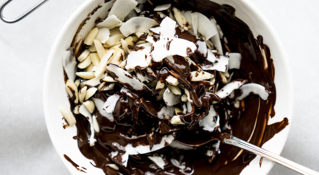 Step 2 is to mix the almond and coconut flakes with melted chocolate